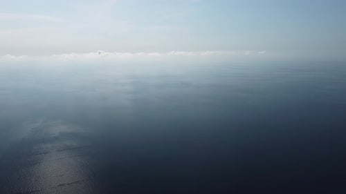 Aerial View From Above on Calm Azure Sea and Volcanic Rocky Shores