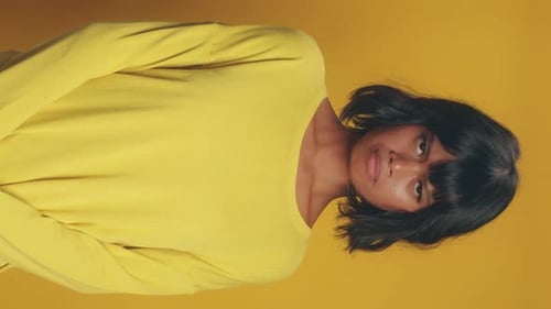 Vertical View Young Ethnic Asian Woman Looking at Camera and Pursed Lips