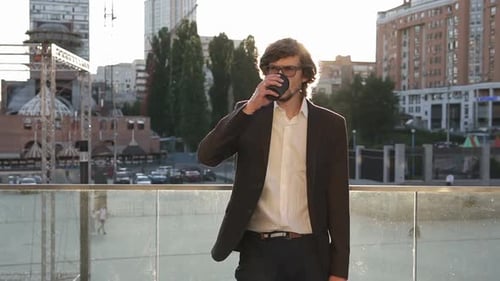 Professional Man Drinks Coffee in Urban Setting