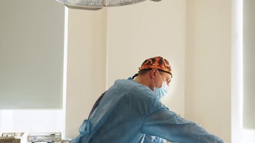 Surgeons Preparing Operating Room Equipment in Hospital