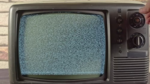 A Hand Is Seaching For A Channel On An Old Tv Camera Zooming Out 1