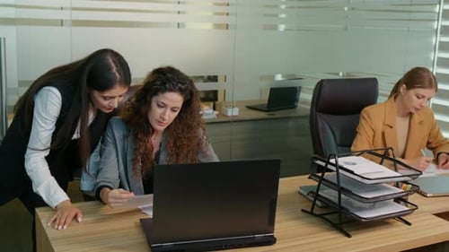 Women Discussing Work in a Modern Office