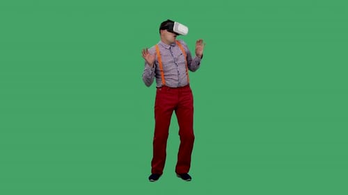 Man Uses VR Headset on Green Background