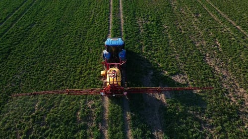 Tractor Spray Fertilizer on Agricultural Field Aerial View