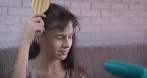 Teen Brushing Hair at Home