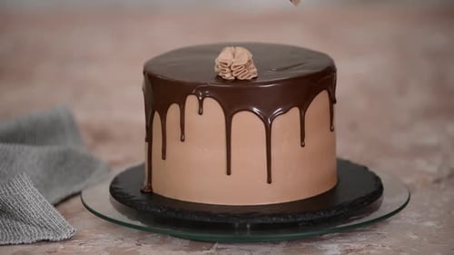 Chocolate Cake Being Decorated With Frosting
