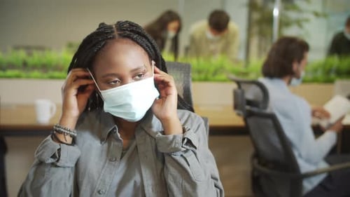 Young Adult Woman Wearing a Face Mask in Office