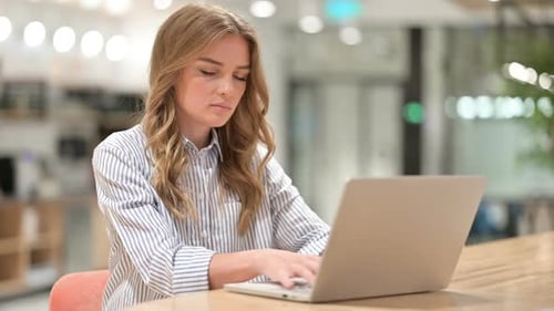 Sick Businesswoman with Laptop Coughing in Office