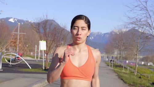 Athletic Woman Doing High Knees Exercise Outdoors