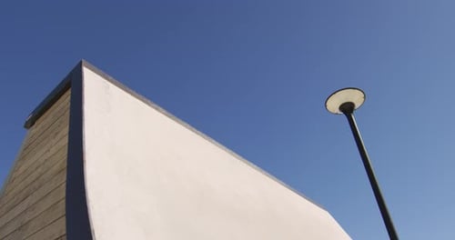 Caucasian man riding and jumping on skateboard on sunny day