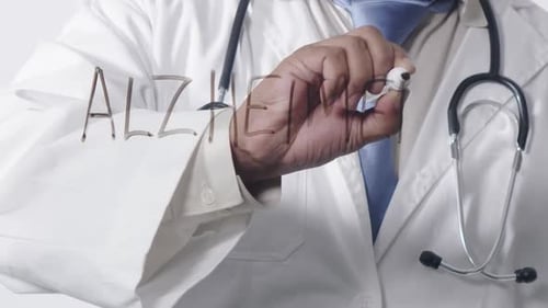 Medical Professional Writes Alzheimer's Disease on Glass