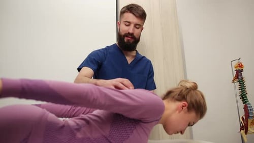 Physical Therapist Treating Woman's Back in Clinic