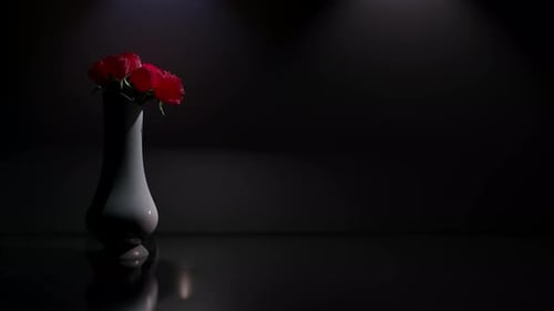 Elegant Vase with Red Roses and Falling Petals