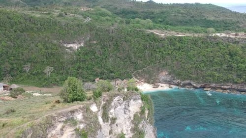 Aerial drone view of coral beach and blue ocean waves In Raja Lima, Nusa Penida, Bali, Indonesia.