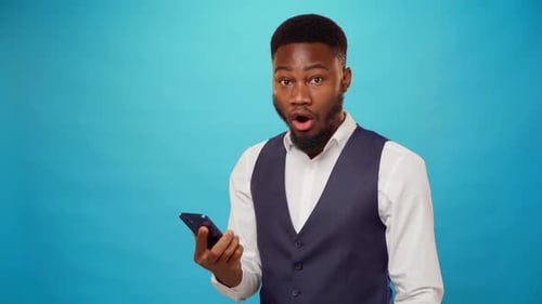 Surprised Young Adult Looking at Phone