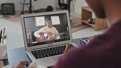 Virtual Music Lesson with Guitar on Laptop