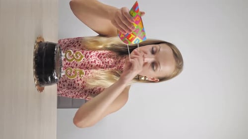 Woman Celebrating Birthday With Cake and Party Hat