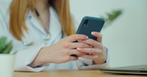 Medical Professional Using Smartphone in a Hospital Office