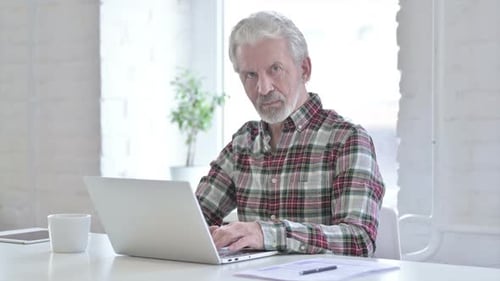 Attractive Casual Old Man Saying No By Finger in Office