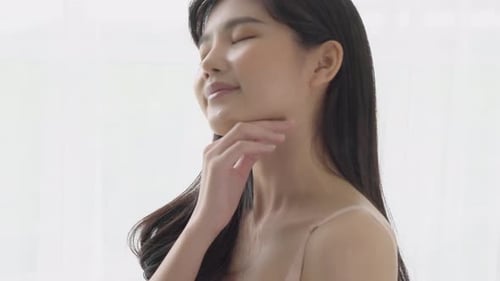 Radiant Woman Enjoying Skincare Routine Indoors