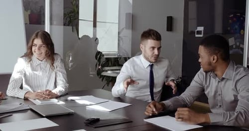 Colleagues Meeting at Conference Table in Office