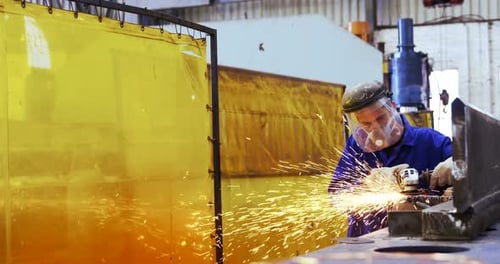 Male engineer using grinder machine 4k