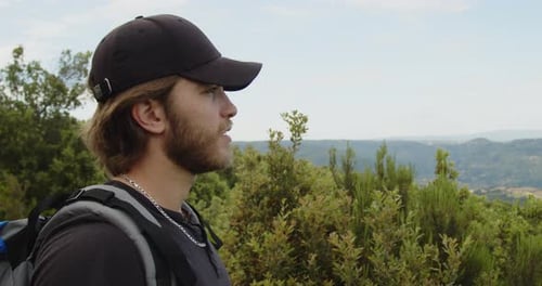 Man Hiking in the Mountains on Sunny Day