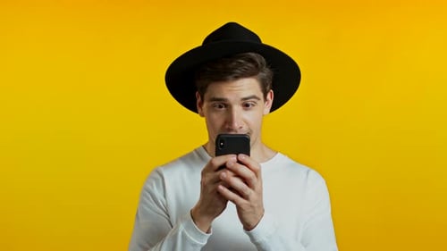 Excited Young Adult Using Smartphone Device
