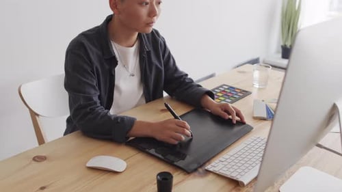 Designer Working at Desk with Graphics Tablet
