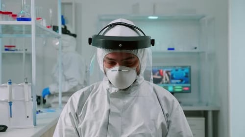 Researcher Wearing Hazmat Suit in Lab