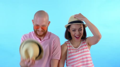 Couple Puts on Matching Hats and Smiles