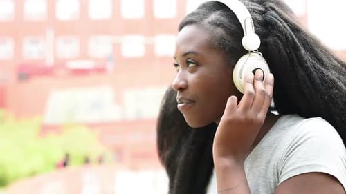 Smiling Woman Listening to Music With Headphones