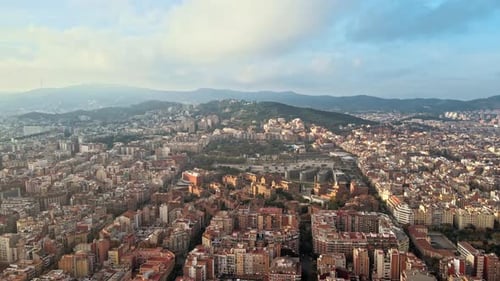 Aerial drone view of Barcelona, Spain. Blocks with multiple residential buildings, hills