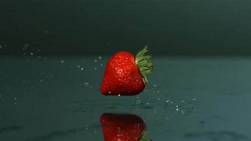 Vibrant Strawberry on Wet Surface with Splashing Water