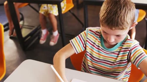 Boy studying in classroom