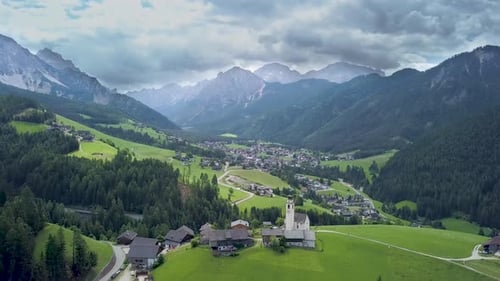 Fly Over Mountain Village in the Dolomites in Italy