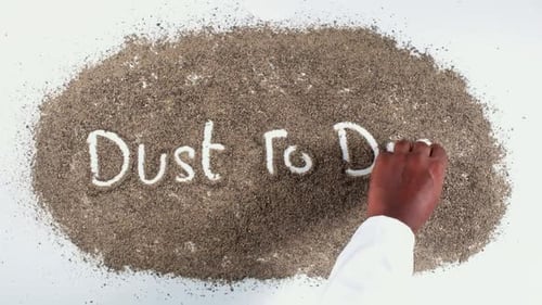 Hand Writing 'Dust to Dust' in Dust