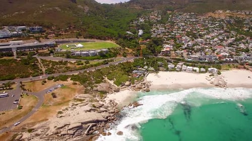 Aerial travel drone view of Camps Bay beach, Cape Town, South Africa.