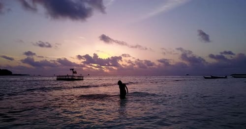 Sexy beauty models on photoshoot having fun on the beach on paradise white sand and blue background