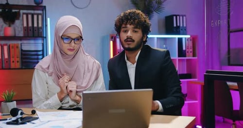 Two Professionals Collaborating in Modern Office