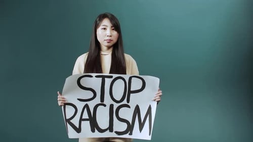 Young Adult Holds Anti-Racism Protest Sign