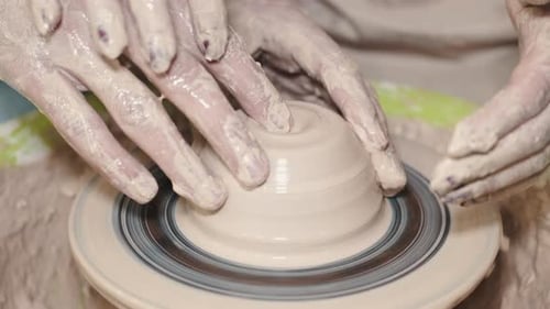 Couple Hands Making a Pot on a Pottery Workshop