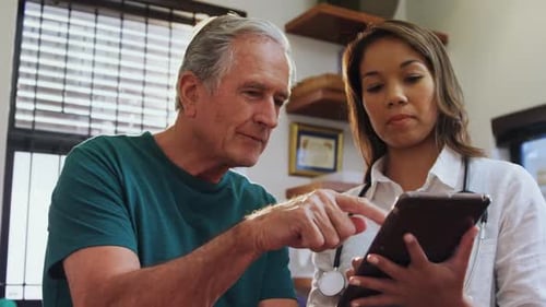 Doctor and Patient Discuss Information on Tablet Device