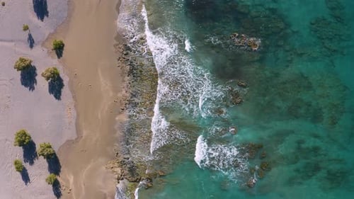 Flying above beach in Greece. Aerial view of Mediterranean Sea coast.