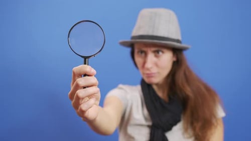 Funny Girl Looking Throw Magnifier To the Camera