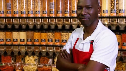 Smiling Man Giving Thumbs Up in Bulk Food Store
