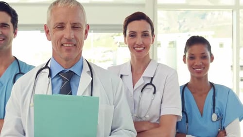 Team of smiling doctors looking at camera