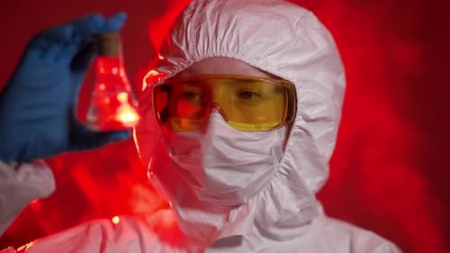 Scientist Examining Chemical in Red Lit Laboratory