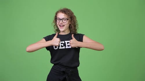 Enthusiastic Young Woman Gives Thumbs Up on Green Screen