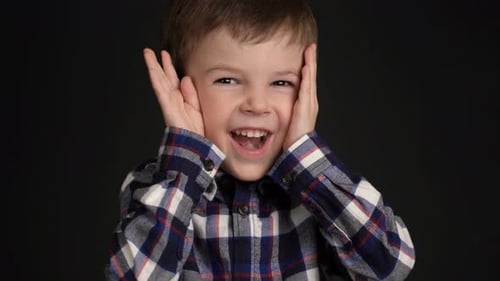 Happy Boy Playfully Covering Eyes in Close Up